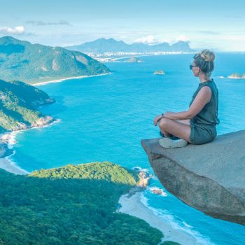 A woman on the edge of the abyss. Pedra do Telegrafo is a tourist destination in Rio de Janeiro. Brazil.